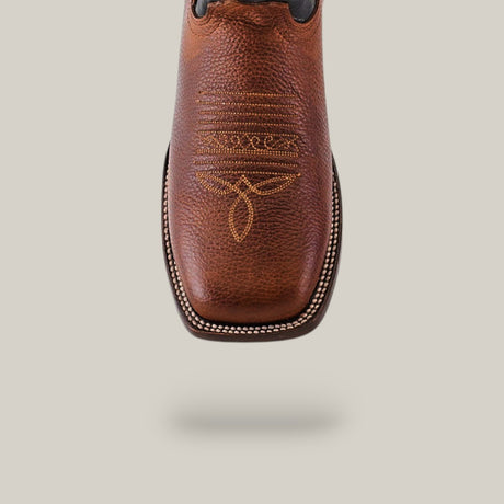 Close-up of Grisly Tan - Square Toe boot in premium leather with intricate toe stitching, white edging on the sole, against a plain light backdrop.