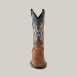A Sierra Cinnamon - Square Toe boot highlights premium craftsmanship with a brown leather foot and intricate blue and beige stitching on the tall shaft, set against a plain, light background.