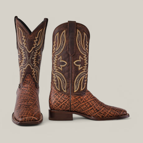 The Mamut Grimm Brown - Square Toe cowboy boots feature premium leather, intricate stitching, and a textured pattern. With a pointed toe and medium-height heel, they are elegantly showcased on a plain background.