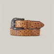 A tan Caiman Print Orix Belt with an ornate Texas buckle, featuring engraved detailing, is coiled neatly against a plain cream background.