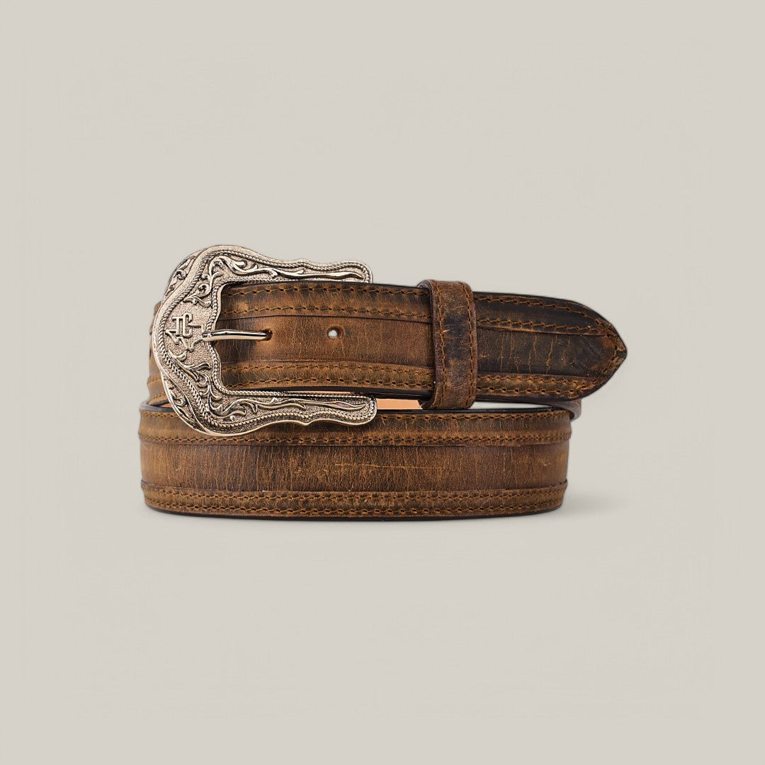 The Azkar Tan Belt - Texas Buckle features a brown leather strap and a Texas Buckle with intricate silver designs, combining rugged sophistication and elegance against a neutral backdrop.