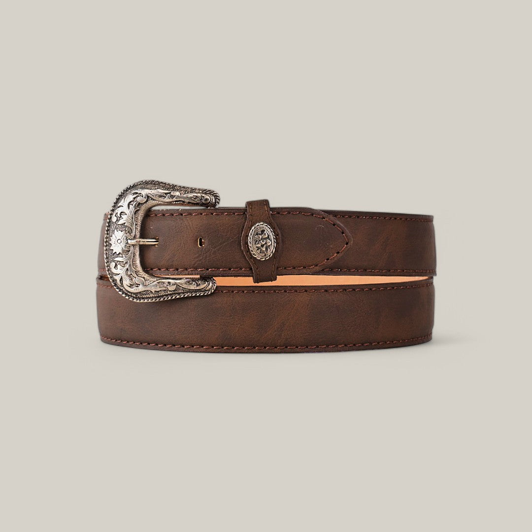 The Brown Plain Belt - Rustic Buckle is a sophisticated accessory, featuring a rustic buckle with intricate floral engravings. Its texture and edge stitching elegantly contrast against a plain beige background.