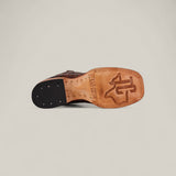 The image shows the sole of the Jonh - Brown - Square Toe premium leather boot with the Texas A&M University logo and TEXAS.COM engraved on tan leather. The dark heel features metal tacks, showcasing quality craftsmanship throughout.