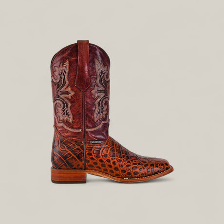 The Jonh - Cogñac - Square Toe from the Last Call collection features a brown leather foot with a crocodile-like pattern, a tall burgundy shaft with white and tan stitching, a low wooden heel, and pull tabs for easy wear.