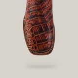 Top view of the Jonh - Cogñac - Square Toe boot, featuring cowhide leather with a crocodile pattern and decorative edge stitching, from the Last Call collection, shown isolated on a light background.