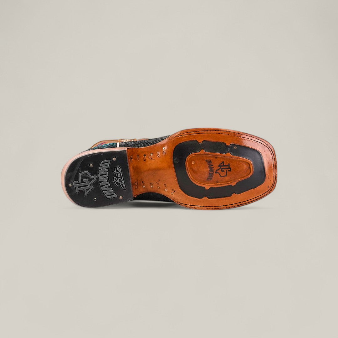 A close-up of the sole of the Exotic Python - Dark Blue - Square Toe mens dress shoe shows brown leather and black rubber with visible stitching and engraved logos, displayed sole-up against a neutral background.