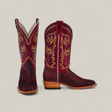 A pair of Exotic Python - Cherry Nobuck Square Toe boots with intricate yellow and white stitching, textured leather foot, and tan wooden heels, displayed on a light beige background.