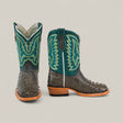 The Exotic Full Quilt Ostrich Gray - Square Toe - Kids Boots feature dark gray ostrich leather, teal green shafts with yellow and teal stitching, light brown soles, and wooden heels—displayed from the front and side on a plain background.