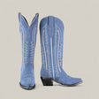 The Elizabeth Light Blue - Tall Shaft Snip Toe boots feature blue suede, decorative white stitching, pointed toes, and angled heels. Displayed against a plain light gray background.