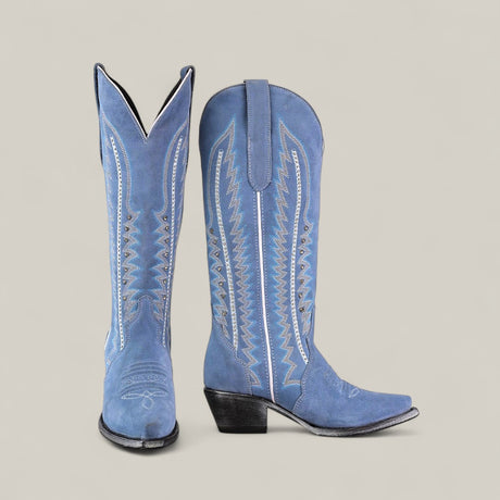 The Elizabeth Light Blue - Tall Shaft Snip Toe boots feature blue suede, decorative white stitching, pointed toes, and angled heels. Displayed against a plain light gray background.