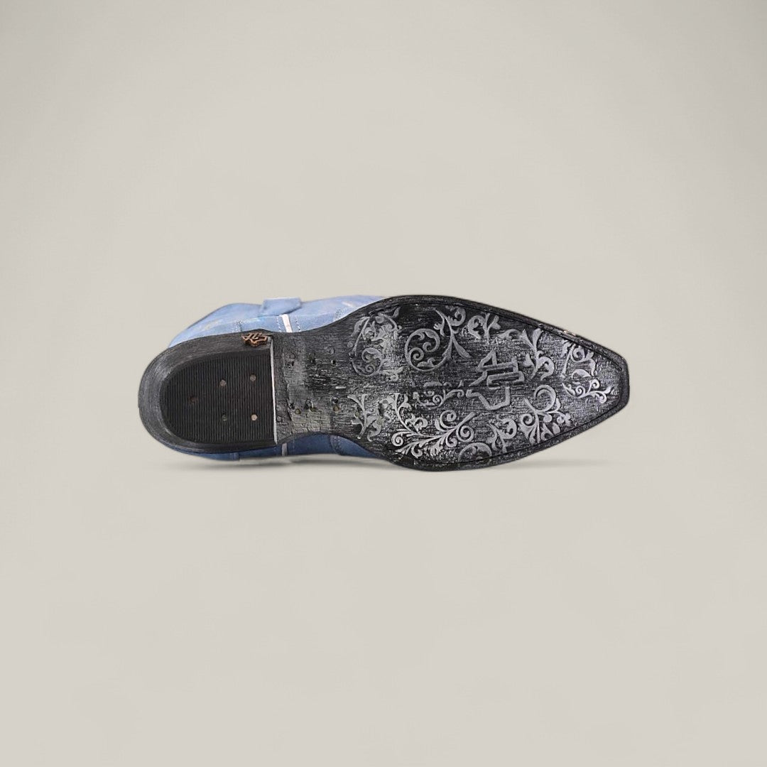 The Elizabeth Light Blue - Tall Shaft - Snip Toe women’s dress shoe is shown on its side, revealing a black sole with detailed floral and swirl engravings plus metallic accents, set against a plain, light background.