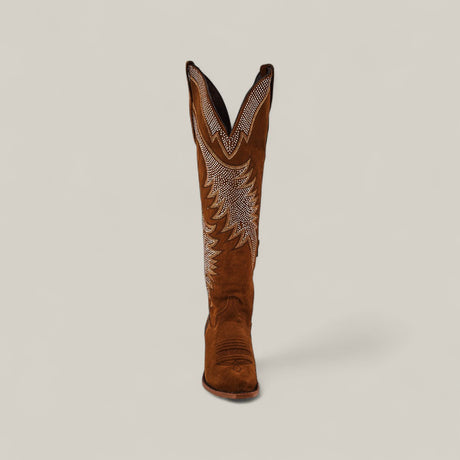 The Daisy Camel - Tall Shaft - Snip Toe features brown suede, white embroidery, and a pointed toe, standing upright against a plain background—an ideal choice to elevate any women’s fashion boot collection.