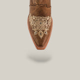 Top view of the Roxanne Crystals Tabaco tall shaft womens boot, featuring brown leather with beige embroidery and decorative patterns on the snip toe, set on a neutral background with a soft shadow underneath.