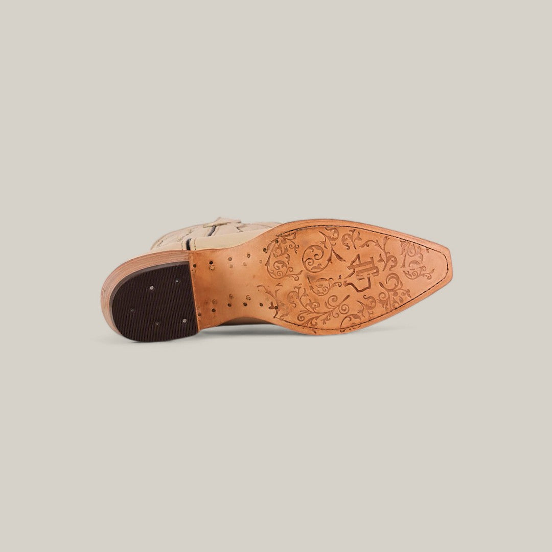 The Tessa Champagne Mid Shaft Snip Toe boot is shown on its side, highlighting its decorative floral-engraved sole and stitched leather heel—ideal for women who value both style and craftsmanship.