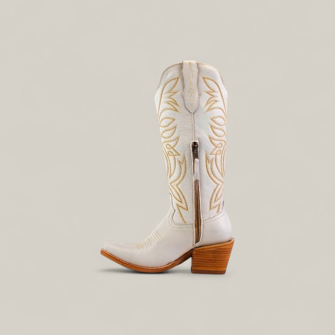 The Kellie Frost White Leather Sole Tall Shaft Snip Toe boot features white leather, tan stitching, a pointed snip toe, side zipper, and chunky wooden heel, shown on a neutral background.