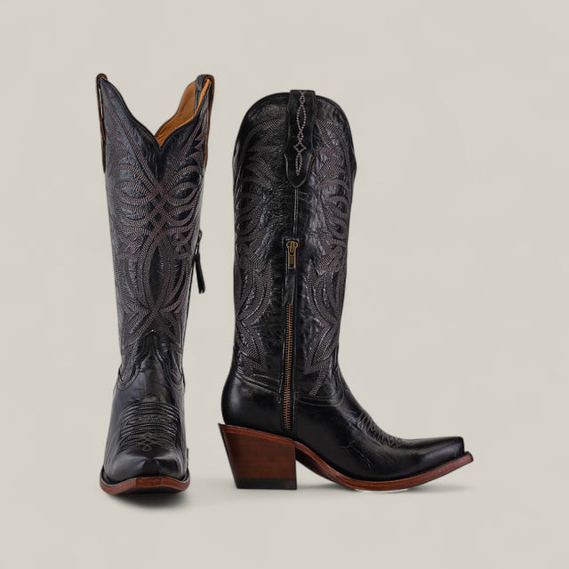 The Kellie Clayton Black Leather Sole boots feature a tall shaft, snip toe, and high wooden heels with intricate stitching and side zippers, displayed against a plain beige background.