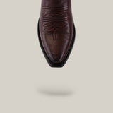 The Miranda Clayton Brownie Leather Sole boot features a brown leather snip toe and decorative stitching, shown from above on a beige background with a soft shadow. Its classic mid-shaft style and quality craftsmanship stand out.