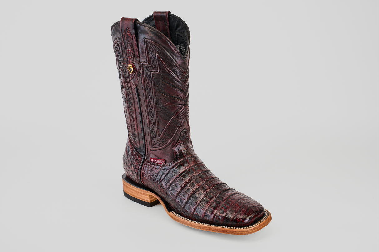 The Exotic Caiman Belly - Black Cherry - Square Toe boot features a dark brown patterned design, decorative stitching, wooden sole, and low heel, showcased individually against a plain light gray background.