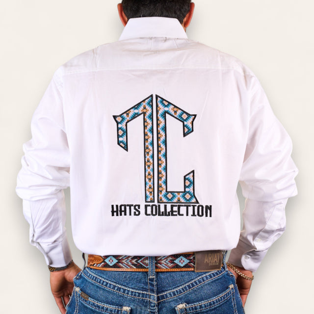 A person shown from behind wears a lightweight white shirt with a bold, colorful TC logo and "HATS COLLECTION" on the back, blue jeans, and the TC Hats - White Blue Aztec patterned belt.