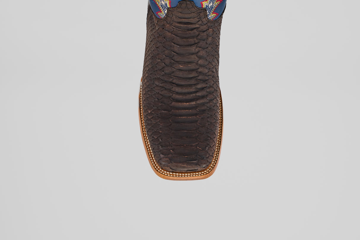 A close-up top view of the Morgan - Matte Brown - Square Toe men’s boot, showing its textured matte brown finish, detailed stitched edge, and a hint of colorful design near the upper.