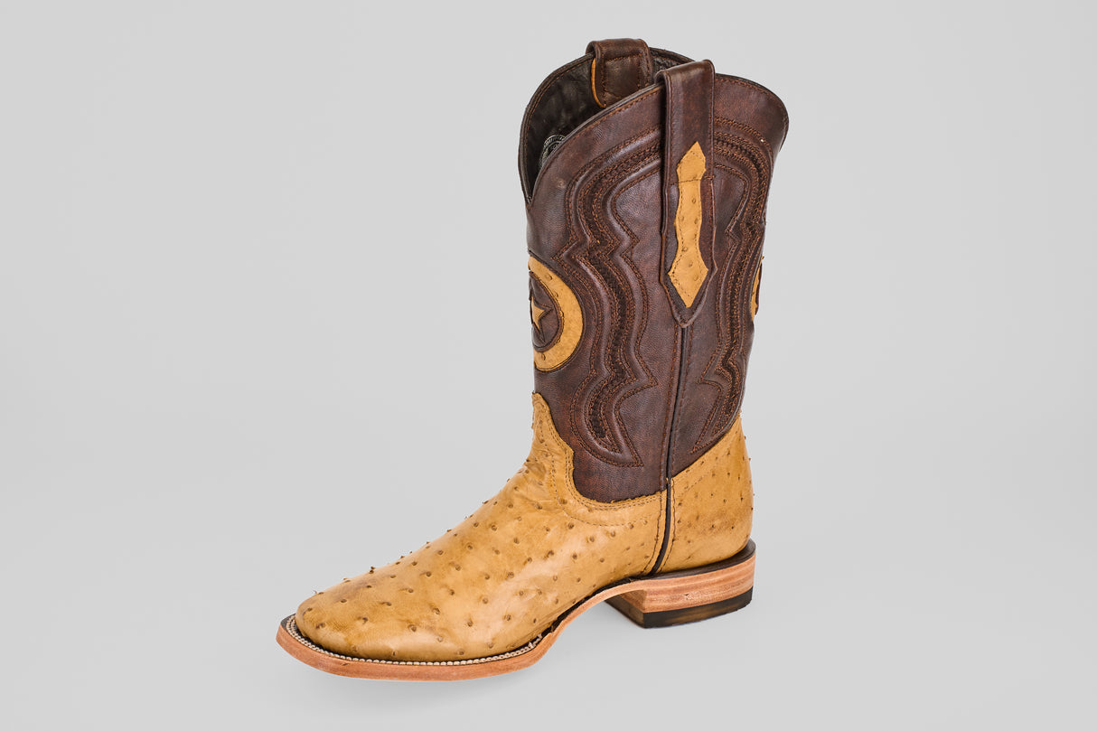 The Exotic Full Quilt Ostrich - Fawn - Square Toe boot features a tan and brown ostrich leather design with a quilted lower and patterned upper, showcased against a plain light gray background.