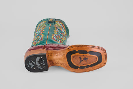 A Rusty - Wine - Square Toe boot with detailed yellow and orange stitching is shown on its side, featuring a square toe, tan sole with black details, and the Diamond brand logo on the heel and sole.