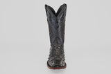 The Exotic Ostrich - Black - Rodeo Toe is a single black cowboy boot featuring a textured, ostrich-style surface and a pointed rodeo toe, shown from the front against a plain white background.