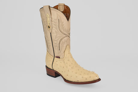 The Exotic Full Quilt Ostrich - Bone - Round Toe boot, featuring a textured genuine ostrich leather foot, decorative shaft stitching, pull straps, and a brown wooden heel, is displayed on a light gray background.