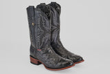 A pair of Exotic Full Quilt Ostrich boots in black with round toes and textured leather, featuring decorative stitching and brown wooden soles, displayed against a plain light gray background.
