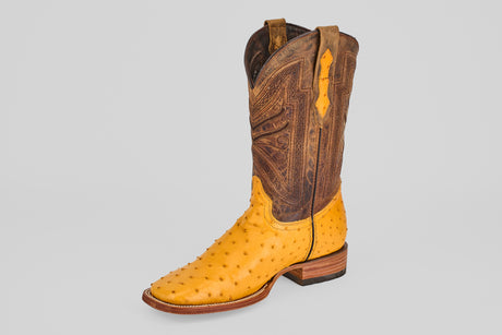 The Exotic Full Quilt Ostrich - Buttercup-Square Toe cowboy boot features a bold yellow ostrich leather foot and tall brown shaft with intricate stitching, displayed on a plain light gray background. Perfect for adding standout style.