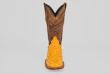 The Exotic Full Quilt Ostrich - Buttercup- Square Toe features a yellow ostrich leather foot and a tall, brown, intricately stitched shaft—shown facing forward on a plain gray background—for handcrafted western boot enthusiasts.