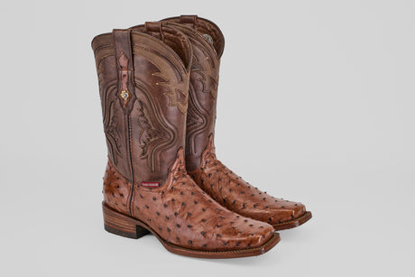 A pair of Austin - Brown - Rodeo Toe high-calf cowboy boots, crafted from avestruz leather with decorative shaft stitching and a square toe, are displayed on a light gray background.