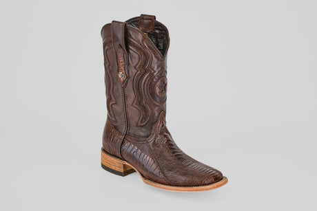 The Austin Leg - Brown - Square Toe boot features decorative stitching, a star-shaped design on the shaft, and a light wooden heel. It is displayed against a plain light gray background.
