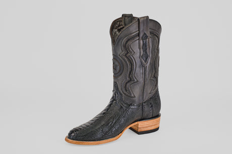 The Austin Leg - Black - Roper Toe is a single black western boot with decorative shaft stitching, a textured leather foot, and a light brown wooden heel and sole, set against a plain white background.