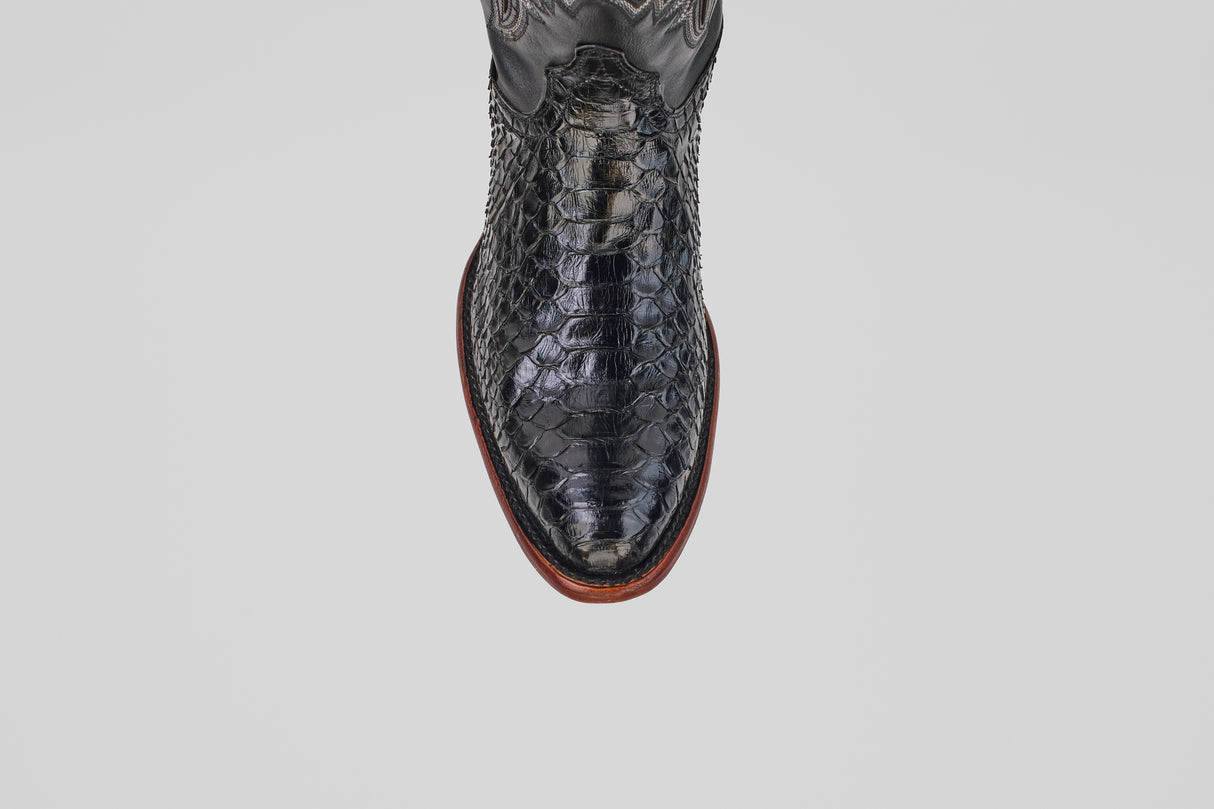 A top-down view of the Tanner - Black - Round Toe cowboy boot in textured Python Negro Oval leather with a reptile-like pattern and brown sole, set against a plain white background.