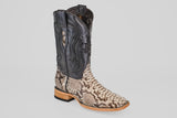 The Tanner - Natural - Square Toe cowboy boot features a tan and brown Python Natural (PN30) snakeskin-patterned lower, black leather upper with decorative stitching, and a wooden heel paired with a black rubber sole.