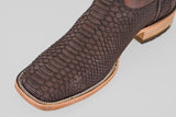 Close-up of the Tanner - Matte Brown - Square Toe boot, featuring a textured, scale-like leather pattern, light-colored stitching along the edge, and a light wooden sole.