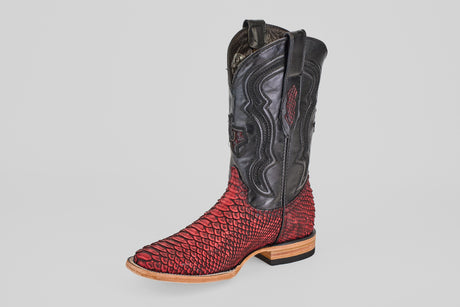 The Tanner – Scarlet – Square Toe is a western cowboy boot with a red snakeskin-textured lower, black upper, decorative stitching, square toe, and a light brown sole, shown against a plain white background.