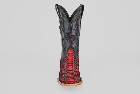 The Tanner – Scarlet – Square Toe is a western cowboy boot with a black upper and red python leather lower, detailed stitching, light brown sole, and square toe, shown from the front against a plain background.