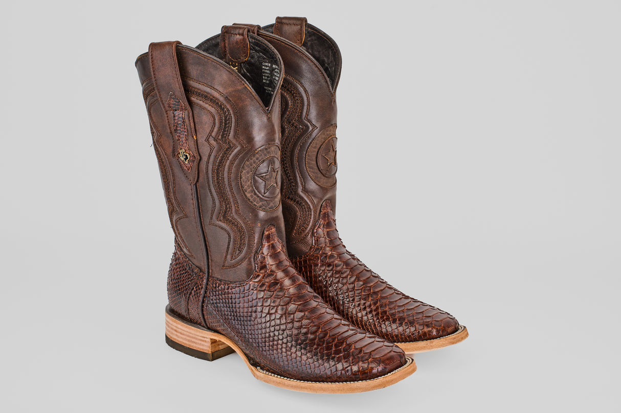 The Tanner - Brown - Square Toe boots feature textured, snakeskin-patterned leather on the foot, smooth leather with decorative stitching on the shaft, a light tan sole, and a low heel.