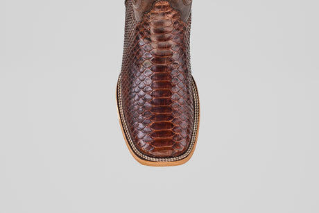 Top view of the Tanner - Brown - Square Toe cowboy boot, showcasing its textured, scaly snakeskin pattern and detailed stitching along the light tan sole.