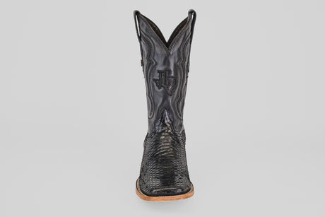 A single Tanner - Black - Square Toe cowboy boot in Python Negro leather, featuring decorative stitching and a wooden sole, is shown from the front against a plain light background.