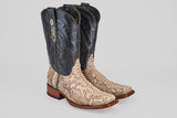 The Tanner - Natural - Rodeo Toe cowboy boots feature python natural leather on the foot, dark brown uppers with decorative stitching, and a wooden heel, shown on a light gray background—ideal for your next rodeo.