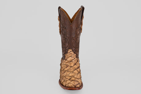The Conor - Matte Orix - Narrow Square Toe features a single cowboy boot with textured tan Pirarucu leather in a matte finish and a dark brown, intricately stitched upper, shown on a plain light gray background.