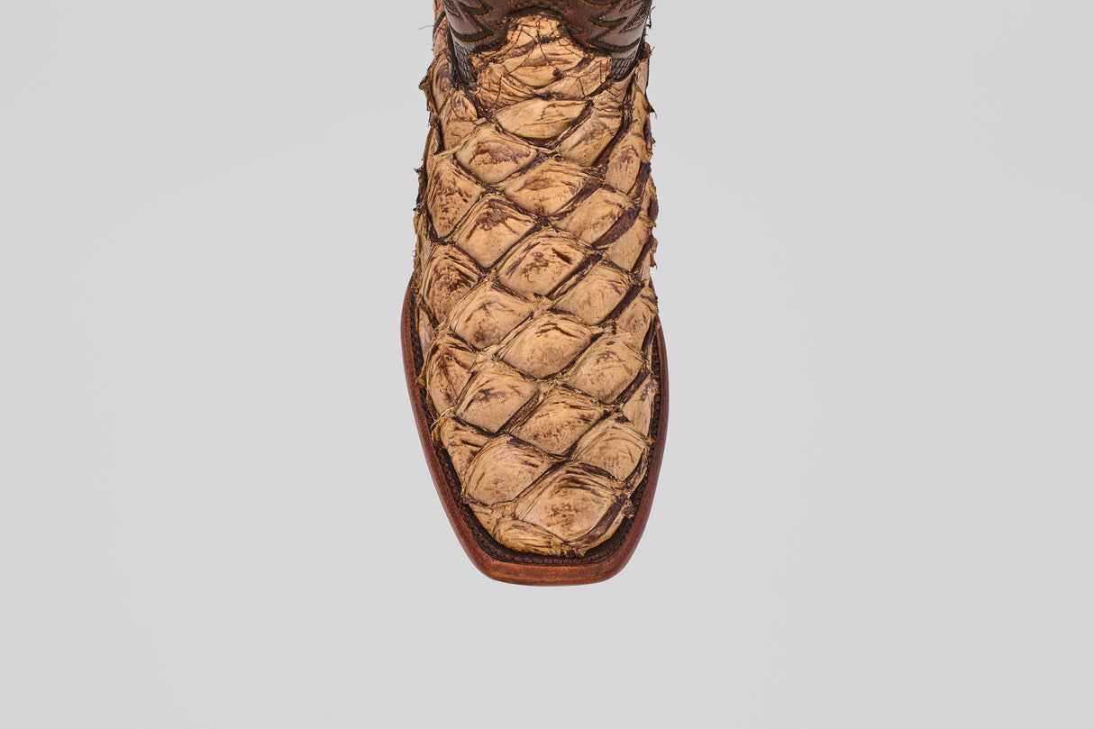 A close-up, top-down view of the toe and front upper part of the Conor - Matte Orix cowboy boot, featuring a narrow square toe and a distinctive textured Pirarucu leather pattern in a tan finish.
