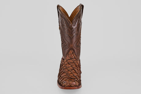 The Conor - Brown - Rodeo Toe boot is shown from the front against a plain white background, featuring detailed stitching on the shaft and a textured, patterned foot.