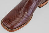 Close-up of the Blaze – Brown – Square Toe Cowboy Boot toe, crafted from lizard leather with beige stitching and a wooden sole, set against a plain light background.