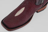 Close-up of the Ranger – Wine – Rodeo Toe cowboy boot, crafted from textured burgundy stingray leather with a white oval inlay on the toe, dark stitching, and a brown wooden heel, set against a light gray background.