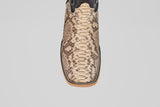A close-up, top view of the Tanner - Matte Natural - Square Toe cowboy boot, showcasing tan and brown python leather with detailed edge stitching.