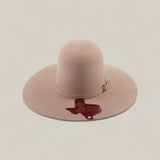The 4X - Belly - TC Hats is a beige Western hat with a wide brim, shapeable crown, decorative band, and a dark red Texas outline with HALF 3 text and a star on the brim.